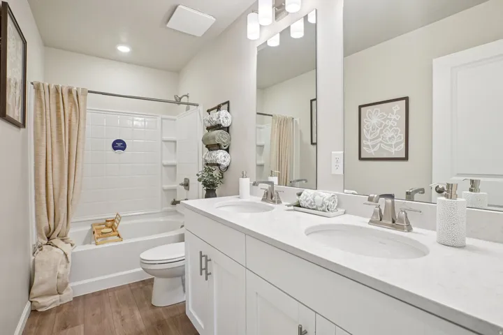 Dual vanity with integrated sinks, brushed nickel fixtures, and a white countertop