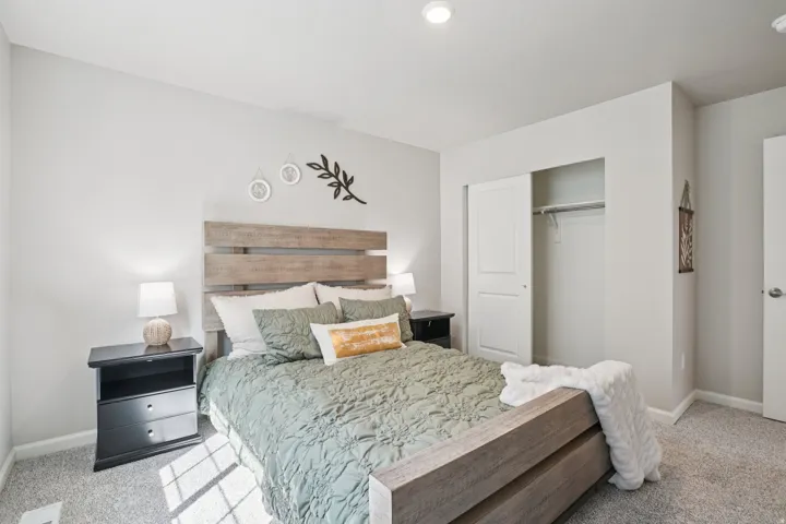 Light gray wall paint, recessed lighting, and soft gray carpeting