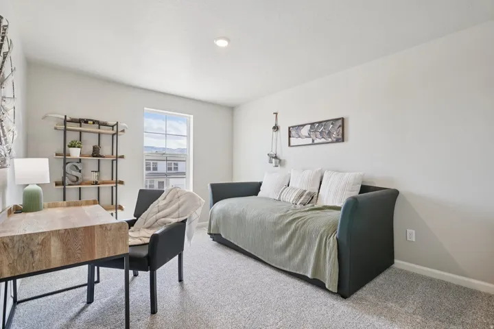 Recessed lighting illuminates neutral-toned walls and speckled carpeting
