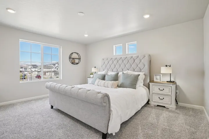 Recessed lighting, large multi-pane window, two transom windows, and light gray wall paint