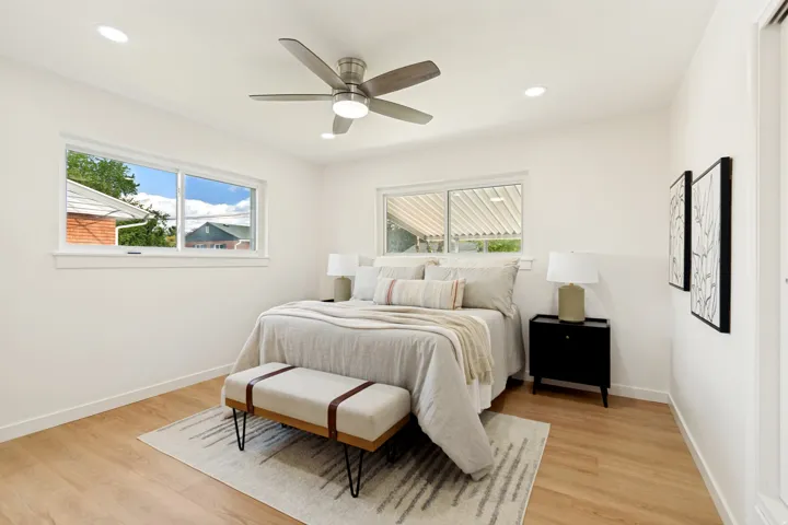Recessed lighting, wood-finish flooring, and a ceiling fan with integrated lighting