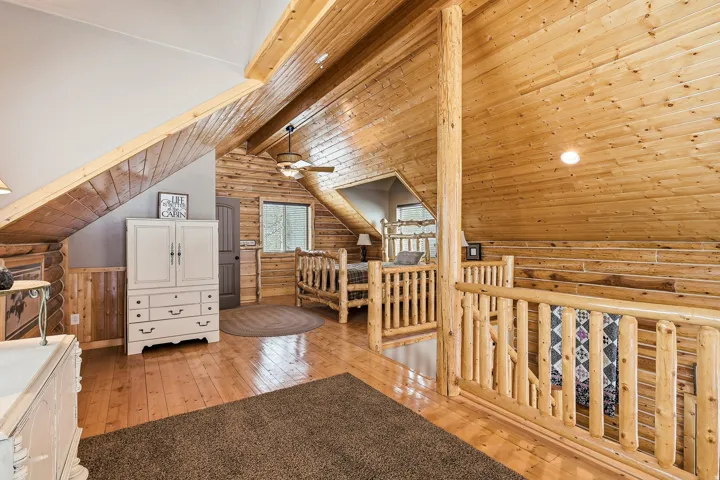 Wood-finish flooring with natural wood plank walls and ceiling