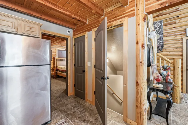 Wood-paneled ceilings, natural wood-clad walls, and tile flooring