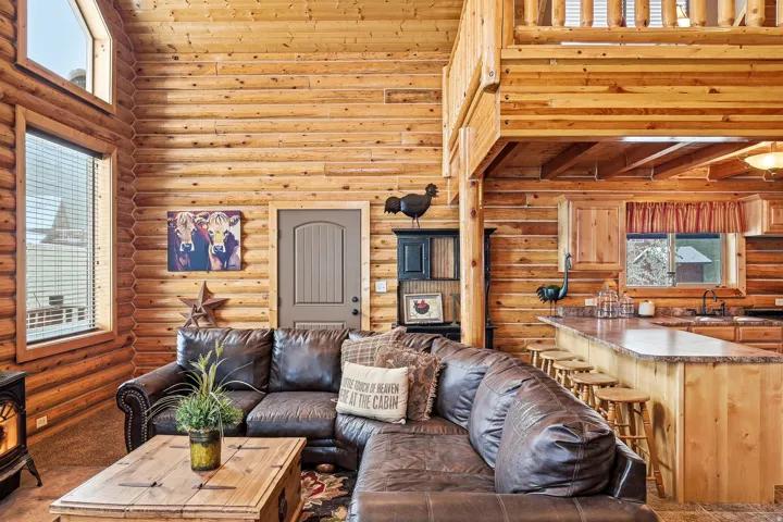 Wood-paneled interior walls, natural wood ceiling beams, and an open-concept design