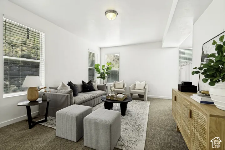 Recessed lighting, white walls, and a textured carpet create a neutral palette
