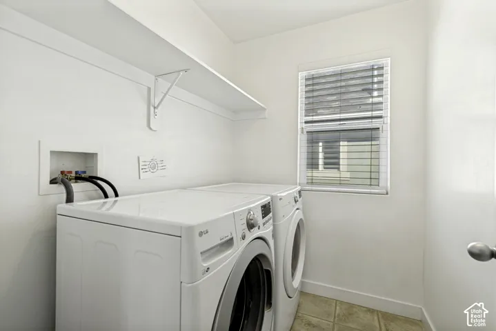 Dedicated laundry area with a single window, a built-in shelf, and tile flooring