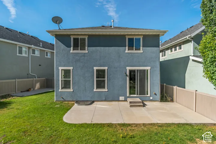 Stucco exterior with multiple windows and a sliding glass door