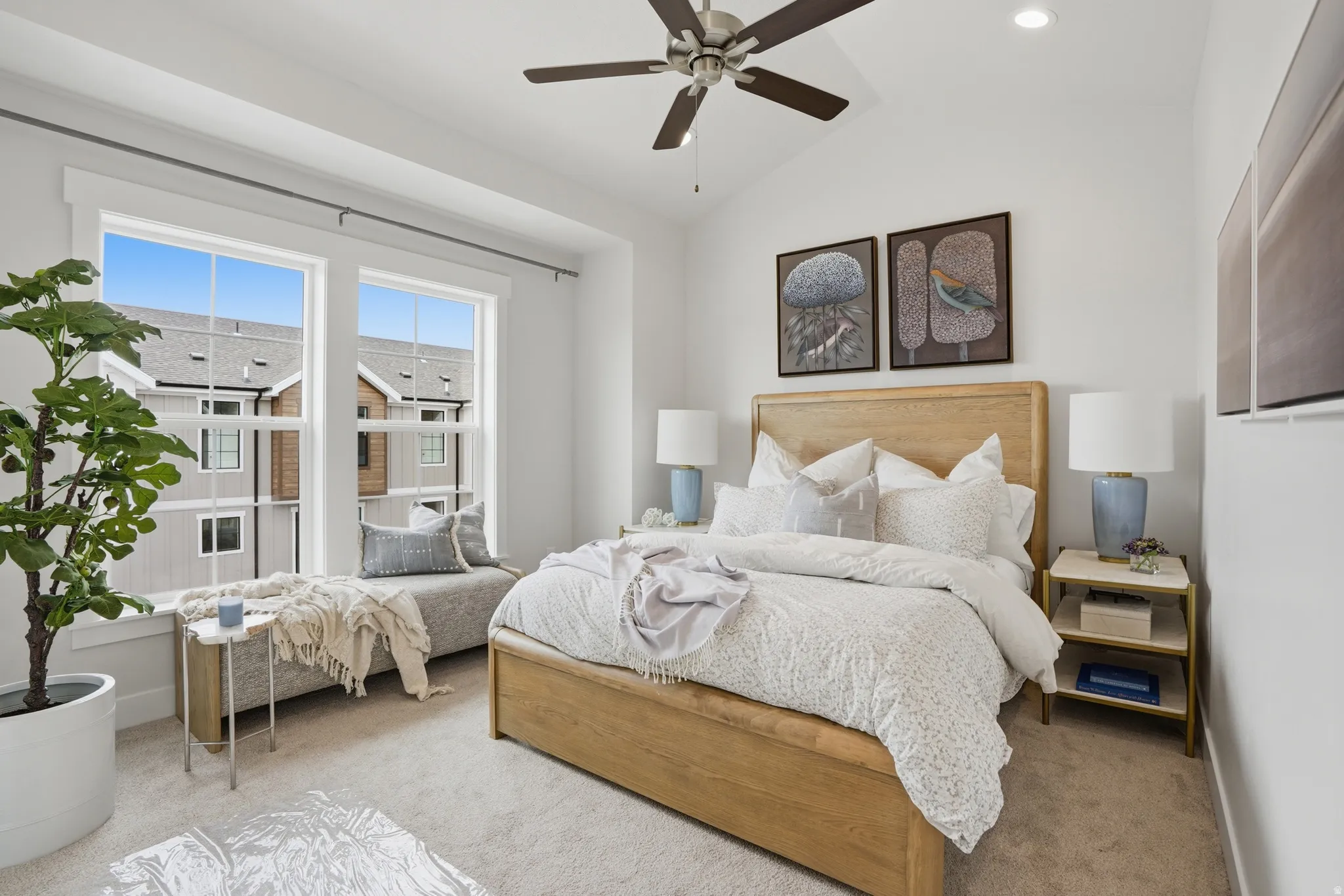 Vaulted ceiling with a ceiling fan, dual large windows, built-in window bench, recessed lighting, and wood-finish flooring