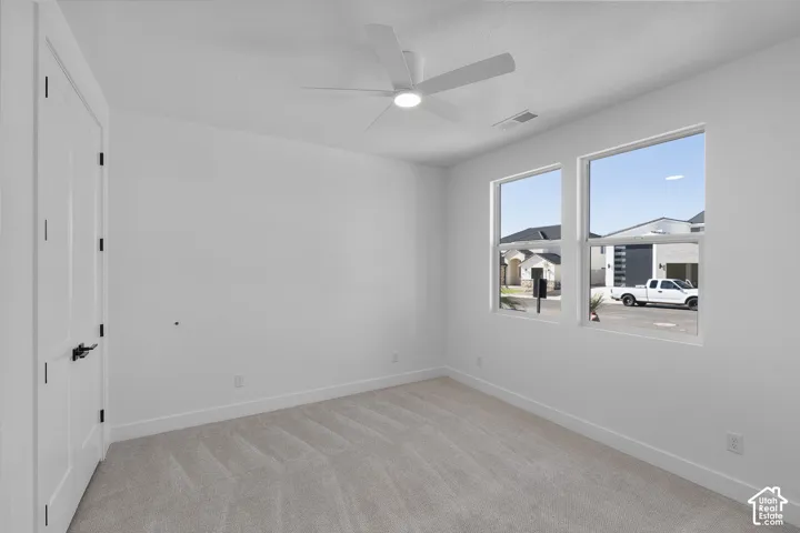 Recessed lighting, two windows, and a ceiling fan with integrated lighting