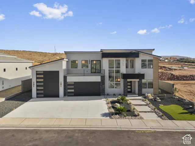 Modern two-story residence featuring a contemporary architectural design with mixed material exterior cladding in stone and horizontal metal accents