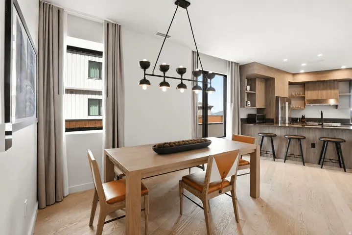 Open-concept living space with light wood-finish flooring