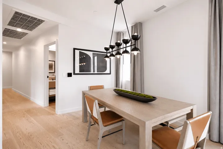 Wood-finish flooring throughout, bright white walls, and recessed lighting