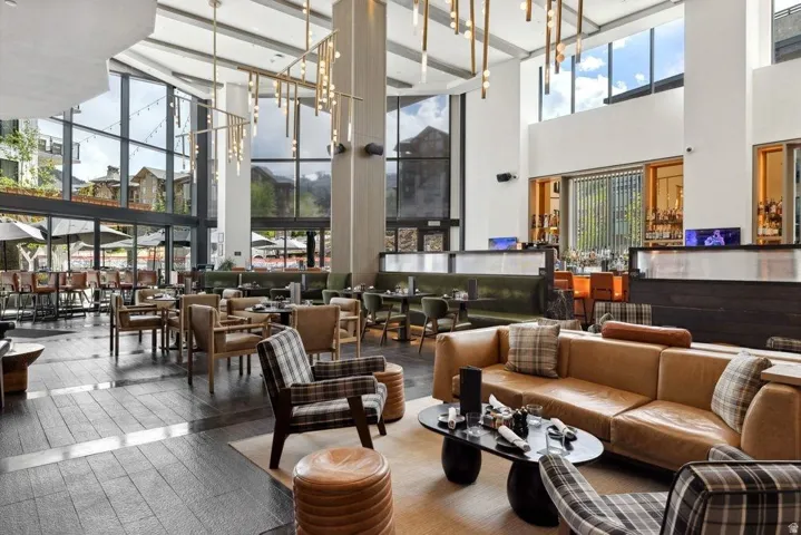 Soaring double-height atrium with floor-to-ceiling windows and natural light throughout
