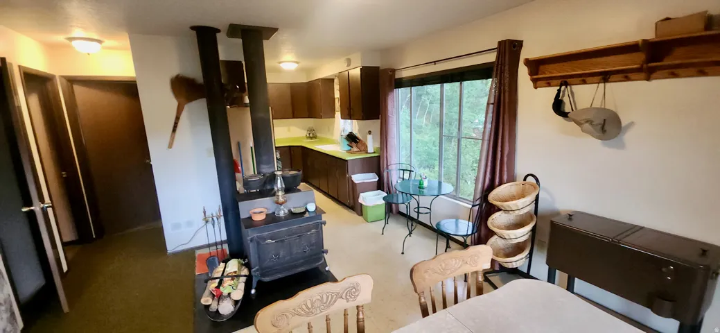 Functional kitchen with wood cabinetry and light green countertops