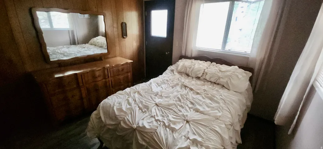Bedroom on Main Floor Dark wood-finish sliding closet doors, Plenty of natural light and separate entrance.