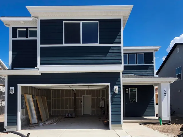 Contemporary two-story exterior with dark blue siding and white trim