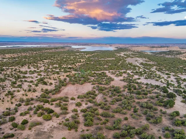 Expansive undeveloped land featuring natural terrain and distant water bodies
