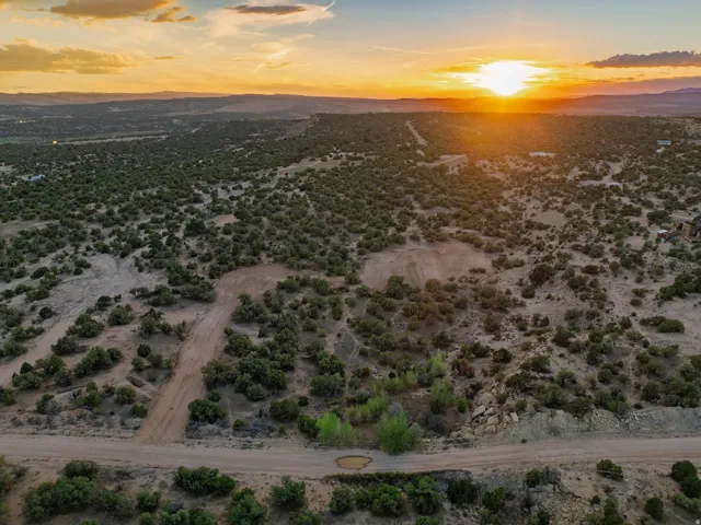 Expansive desert landscape with scattered green vegetation and rolling terrain