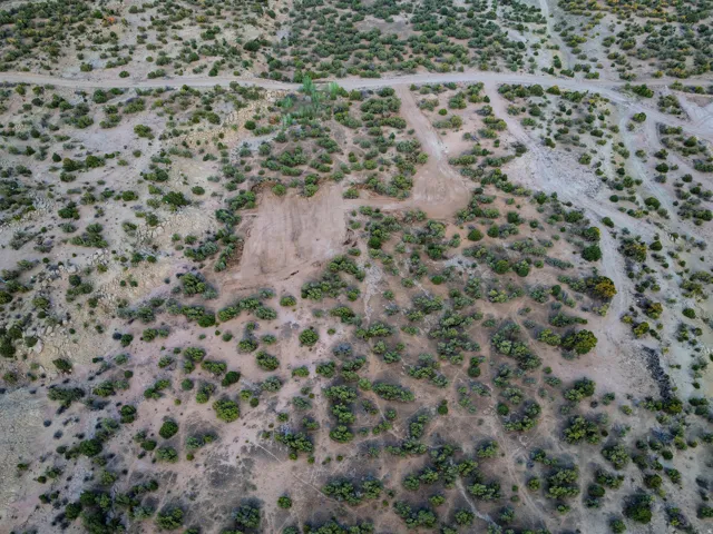 Expansive undeveloped land featuring natural vegetation and visible paths