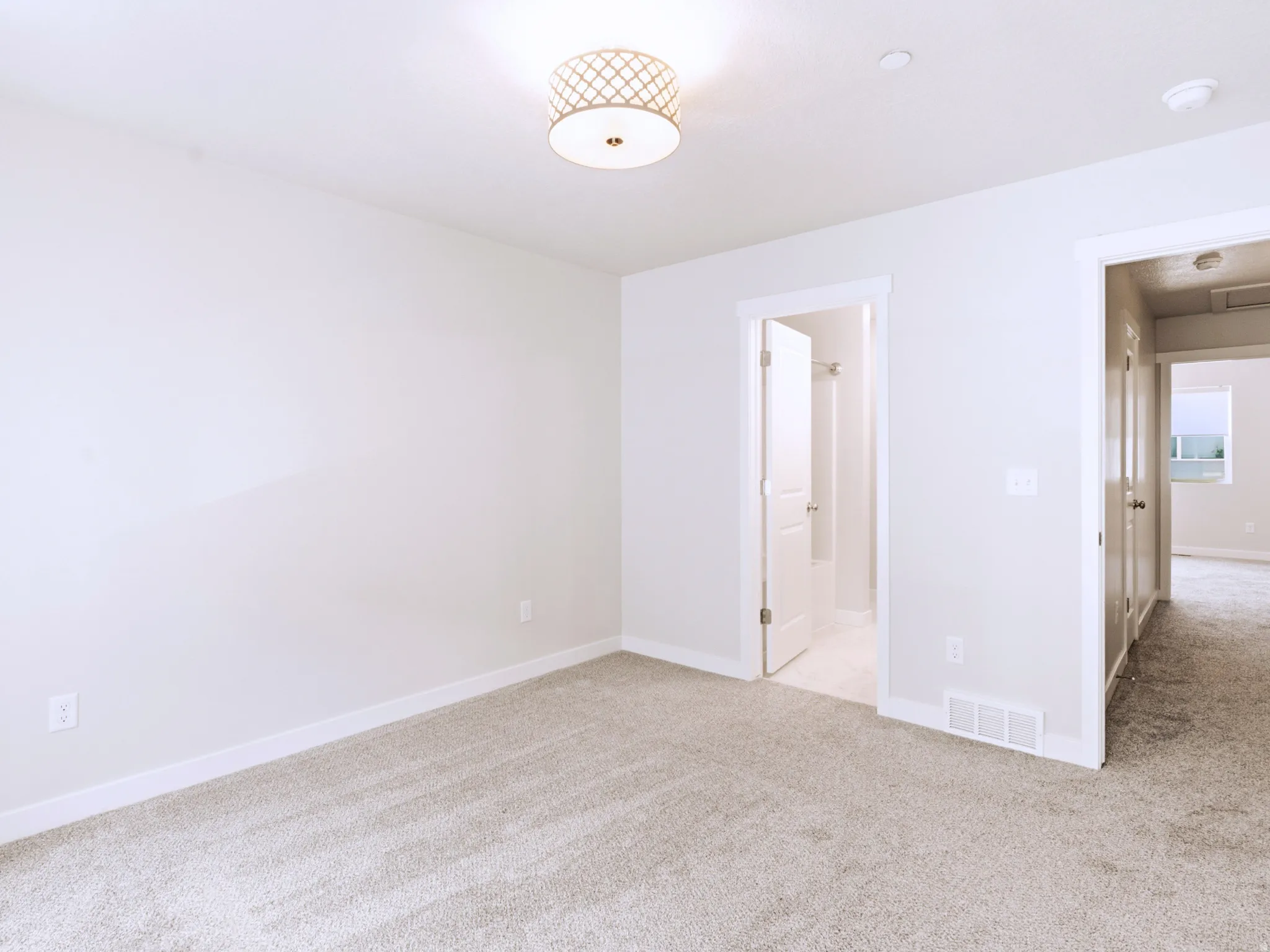 Plush carpeting, recessed lighting, and a drum-style ceiling fixture