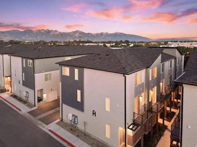Modern townhome development featuring multiple units with individual balconies and mountain scenery