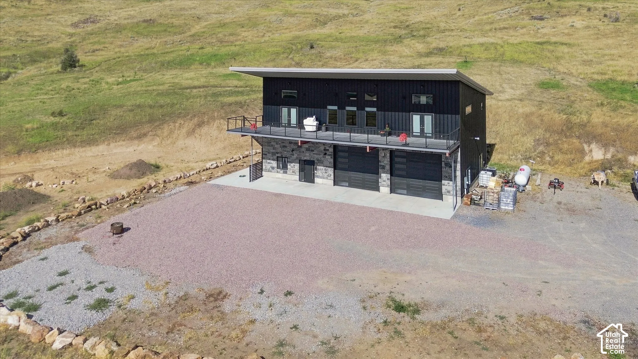 Modern exterior with dark siding, stone accents, and a flat roof