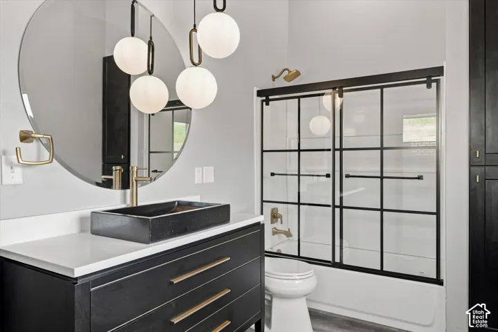 Modern vanity with a rectangular vessel sink, white countertop, and gold-finish faucet