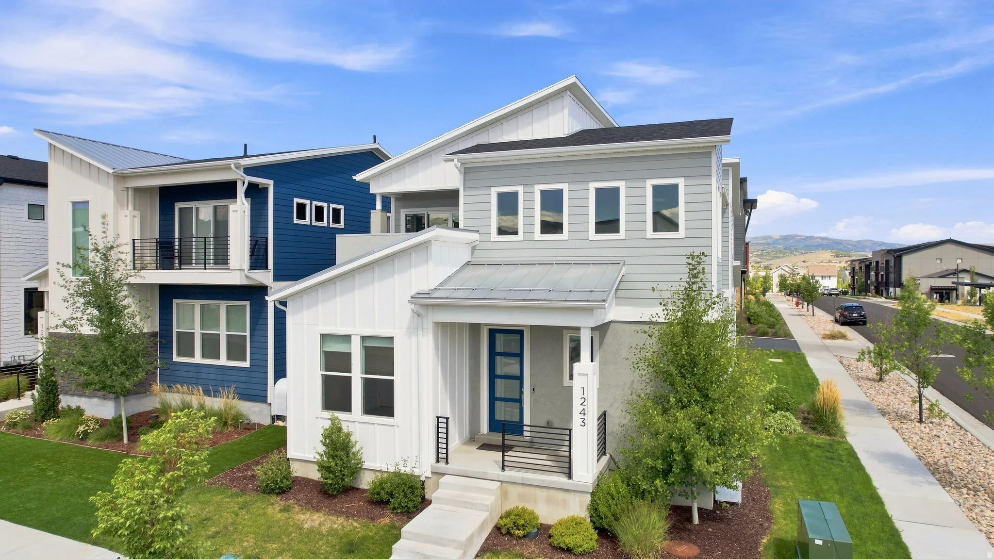 Contemporary exterior with mixed siding, covered entry, and prominent street frontage