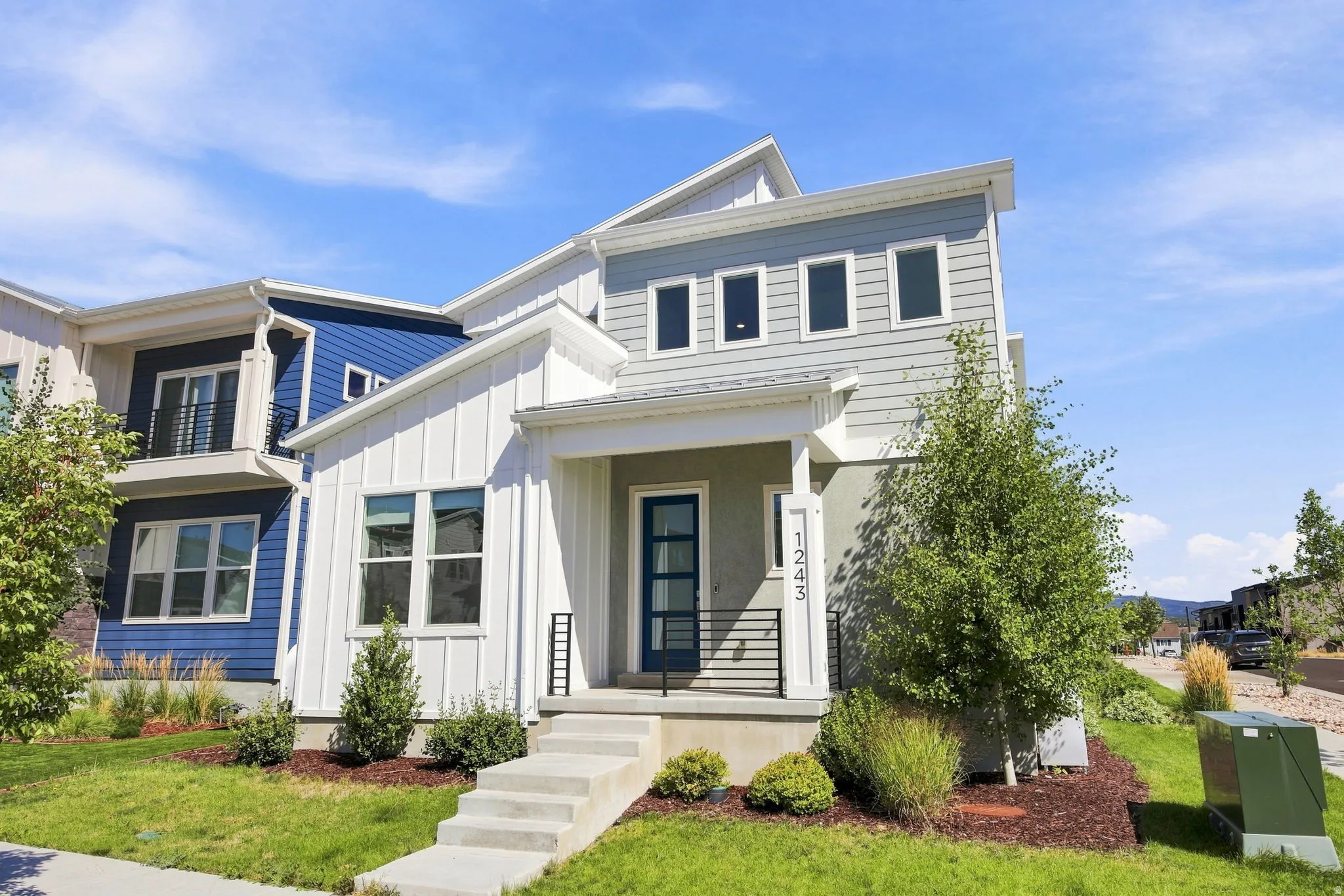 Modern exterior featuring horizontal and vertical siding, a covered entry, and a contemporary front door