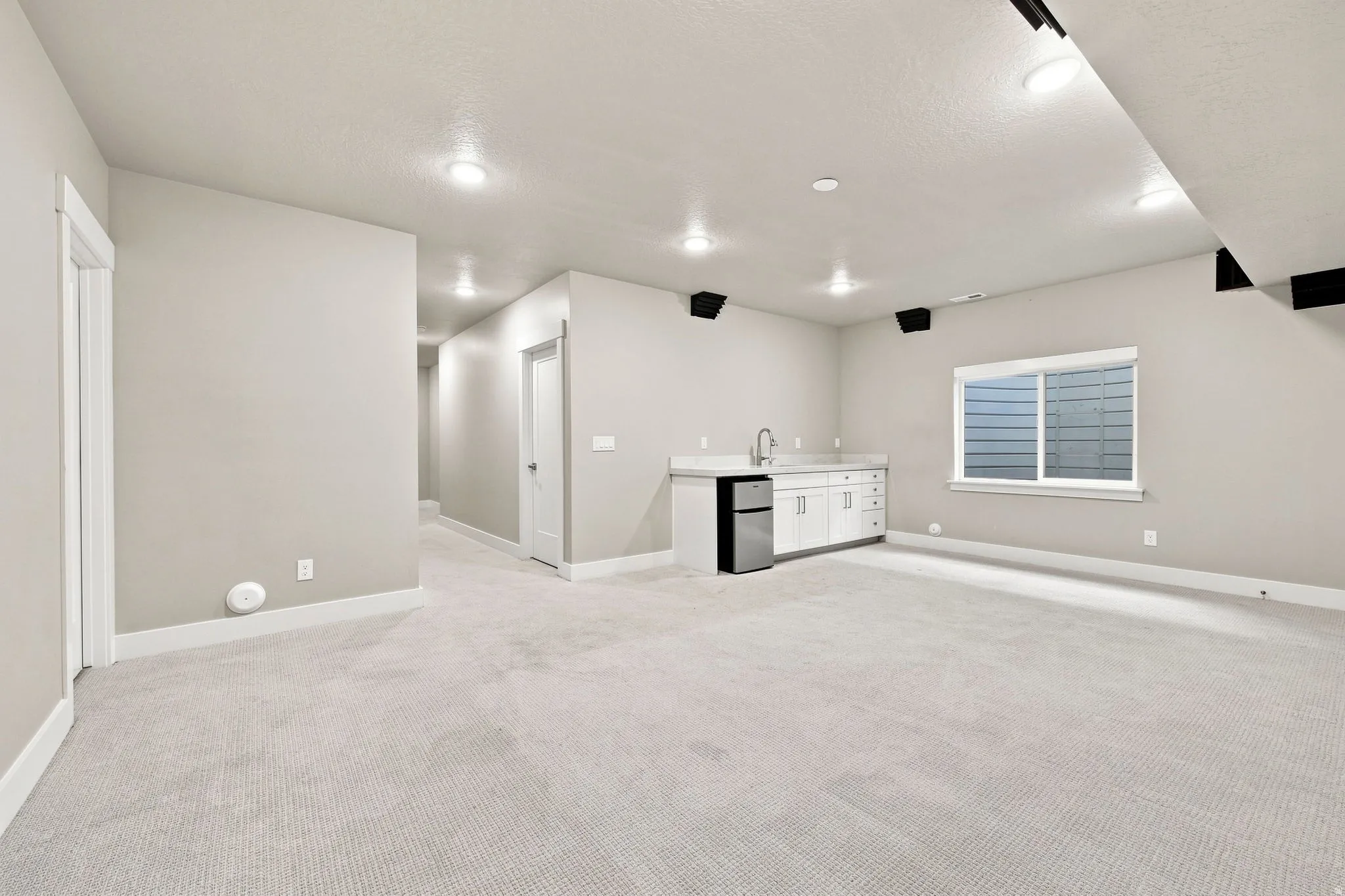 Recessed lighting and carpeted flooring throughout
