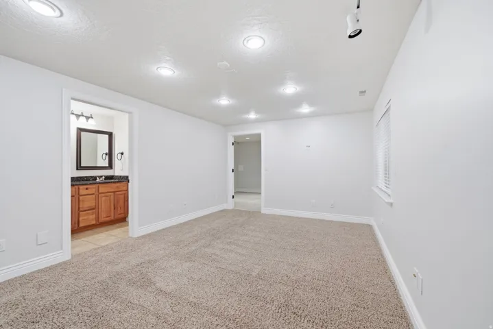 En-suite bedroom with walk-in closet and attached full bathroom.