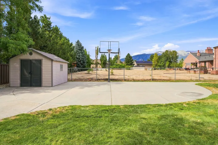 Sport court with basketball hoop.