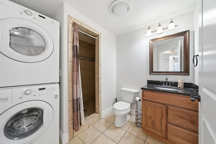 Bathroom with walk-in shower and laundry hook-ups.