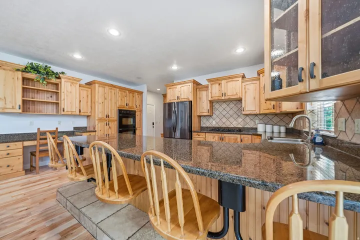 Custom cabinets, built-in stools, double ovens.