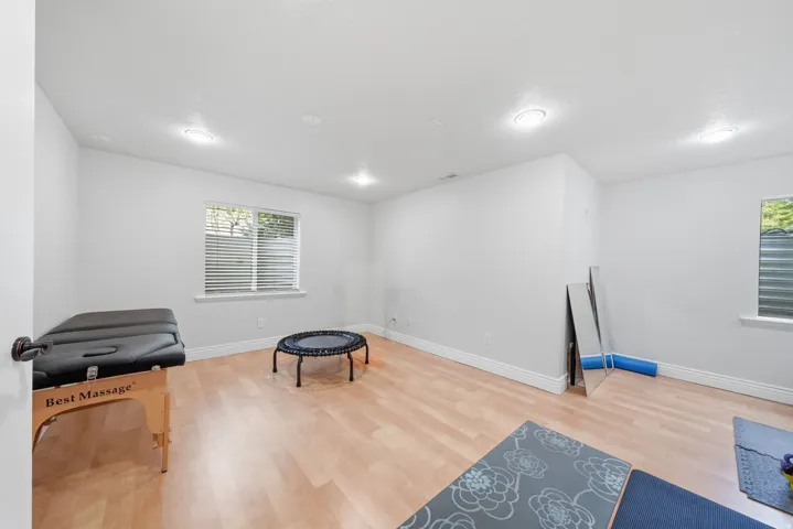 Spacious bedroom with dual windows and recessed lighting.