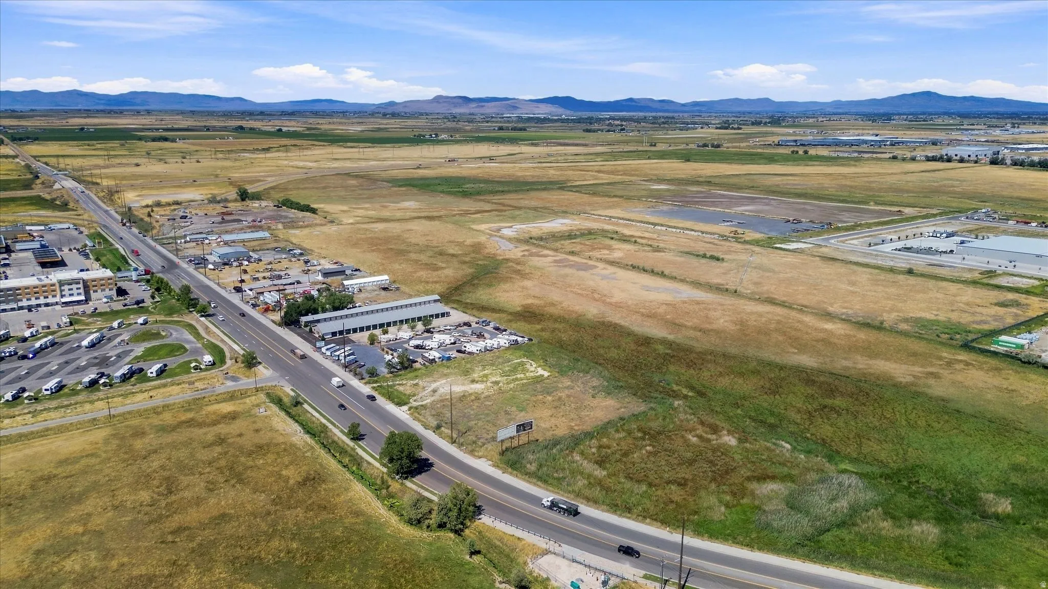 Expansive undeveloped land with a paved road frontage