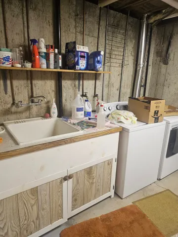 Utility sink with wood-finish base cabinetry