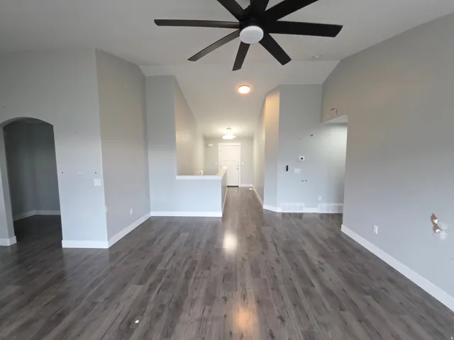 Wood-finish flooring throughout, vaulted ceilings, and a modern ceiling fan
