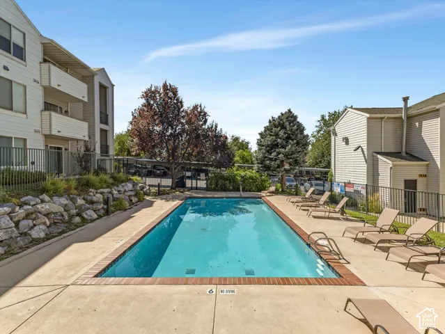 Rectangular swimming pool with a brick coping and concrete surround