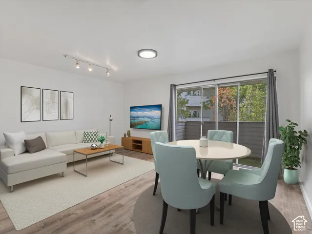 Wood-finish flooring throughout, track lighting, and a sliding glass door to a private patio