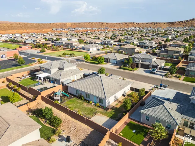 Residential property with a tan stucco exterior, a tiled roof, and a fenced backyard