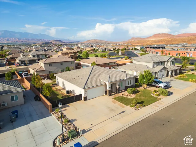 Single-story residence with an attached garage, landscaped front yard, and paved driveway