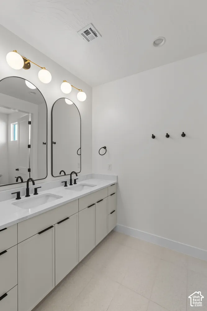 Dual vanity with white undermount sinks, quartz countertops, and matte black fixtures