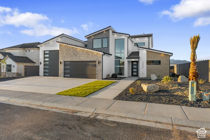 Modern exterior with a multi-textured facade including stone accents and horizontal siding