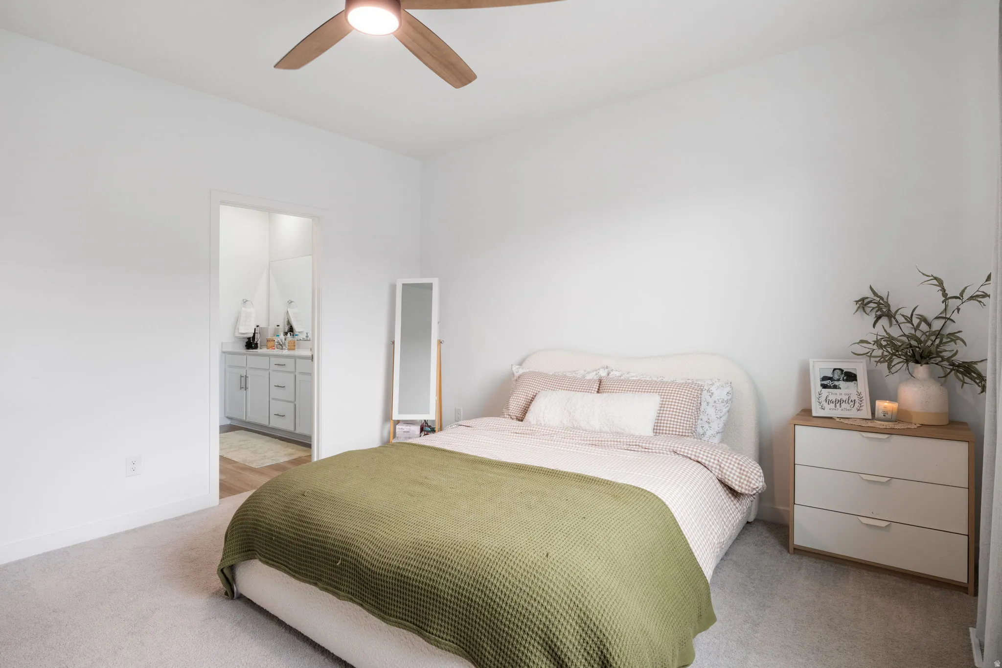 Large Primary bedroom with neutral carpet and Primary bathroom