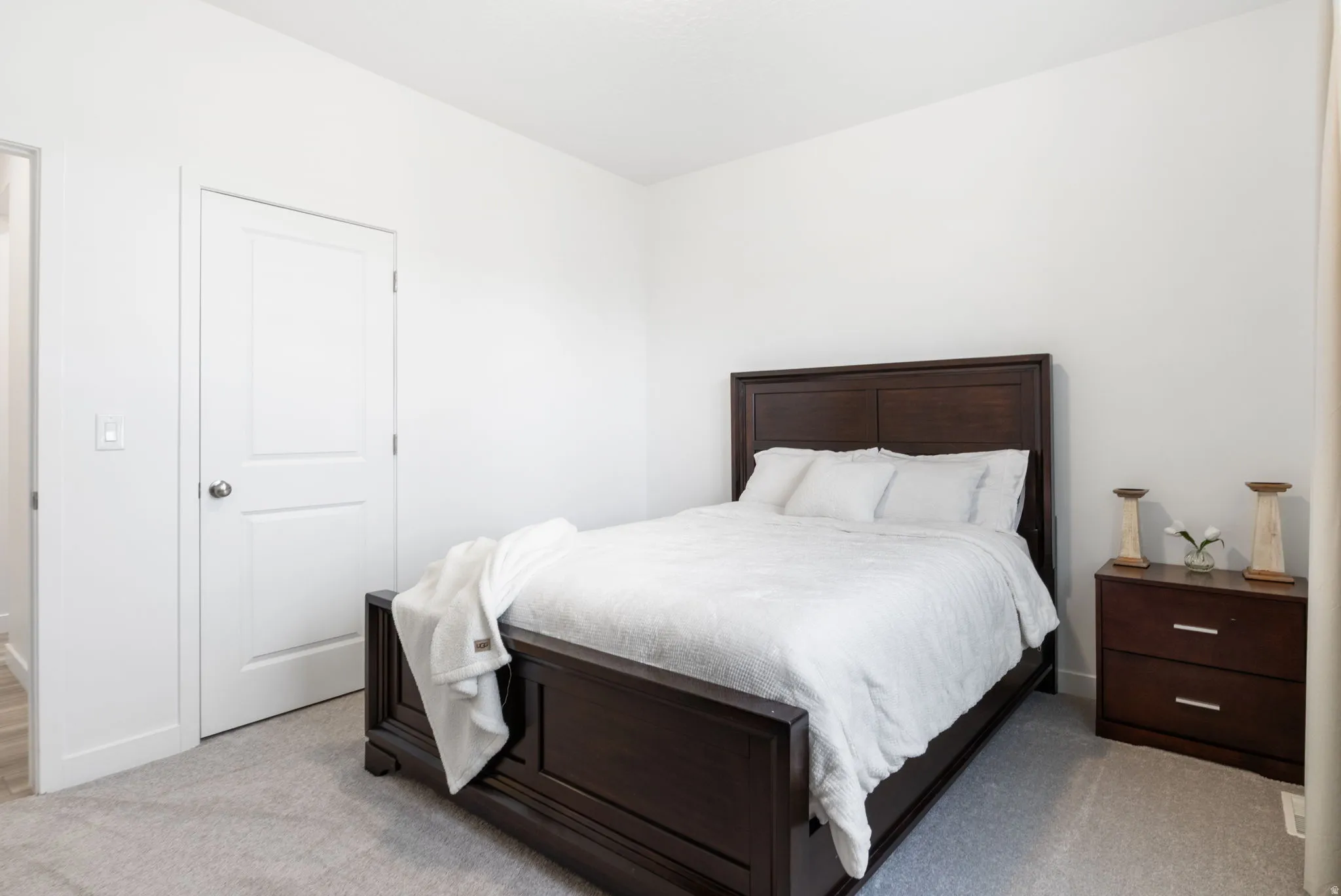 Second bedroom with closet and light carpet.