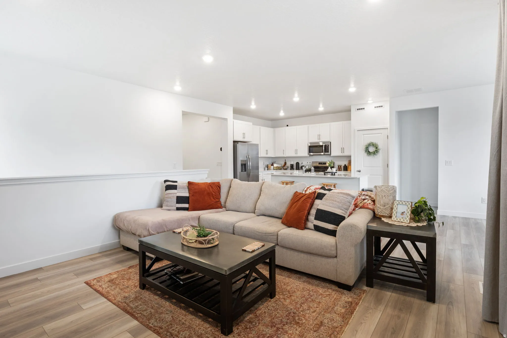 Cozy open-concept living space with light wood-finish flooring