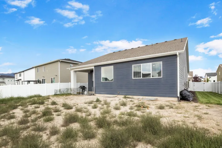 Rear exterior showcasing fully fenced yard side yards are grassed but entire yard will be grassed.