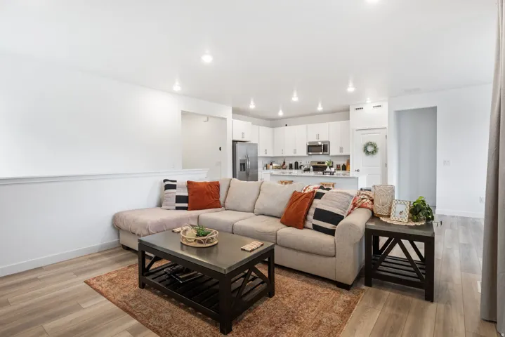 Cozy open-concept living space with light wood-finish flooring
