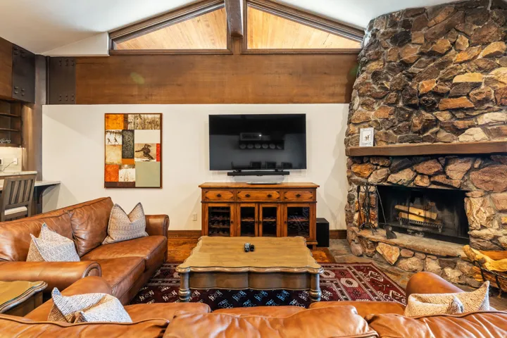Stone fireplace with a wood mantel
